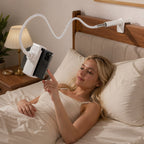 Woman relaxing in bed using Luminomo Arc hands-free phone mount