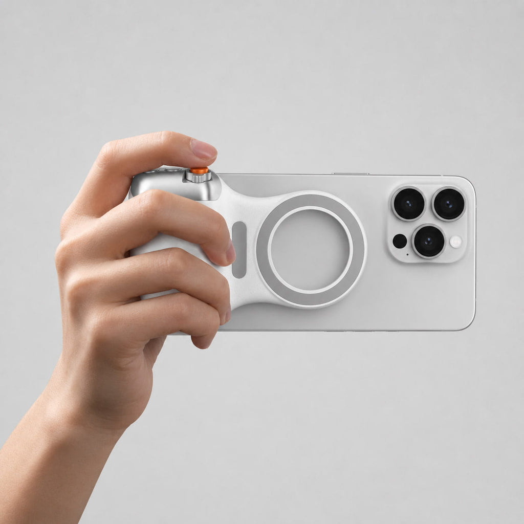 Luminomo Capture magnetic camera grip attached to a smartphone, featuring an ergonomic handheld design with physical shutter controls.