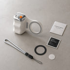 Luminomo Capture magnetic camera grip with included accessories such as wrist strap, magnetic ring, cleaning wipe, adhesive pad, and user guide.
