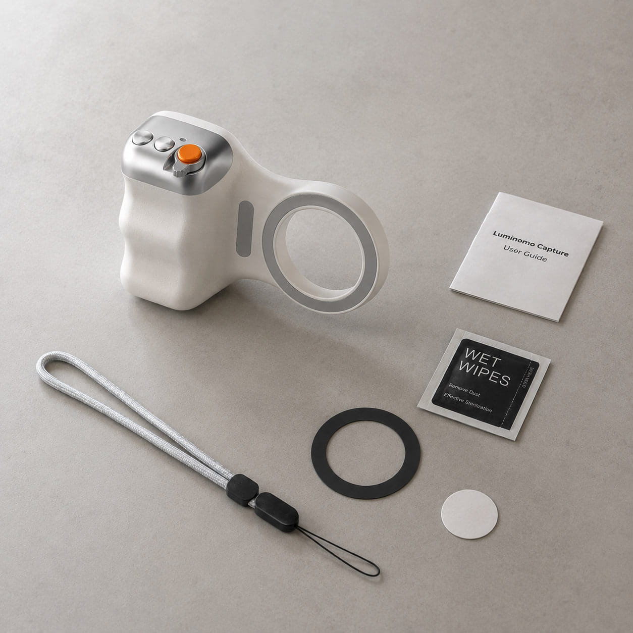 Luminomo Capture magnetic camera grip with included accessories such as wrist strap, magnetic ring, cleaning wipe, adhesive pad, and user guide.