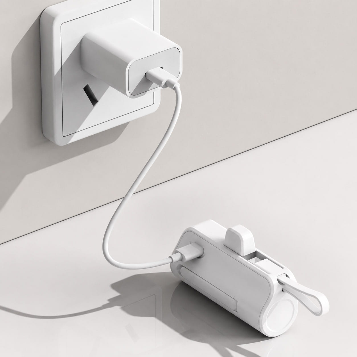 White Luminomo Go portable power bank charging from a USB-C wall charger.
