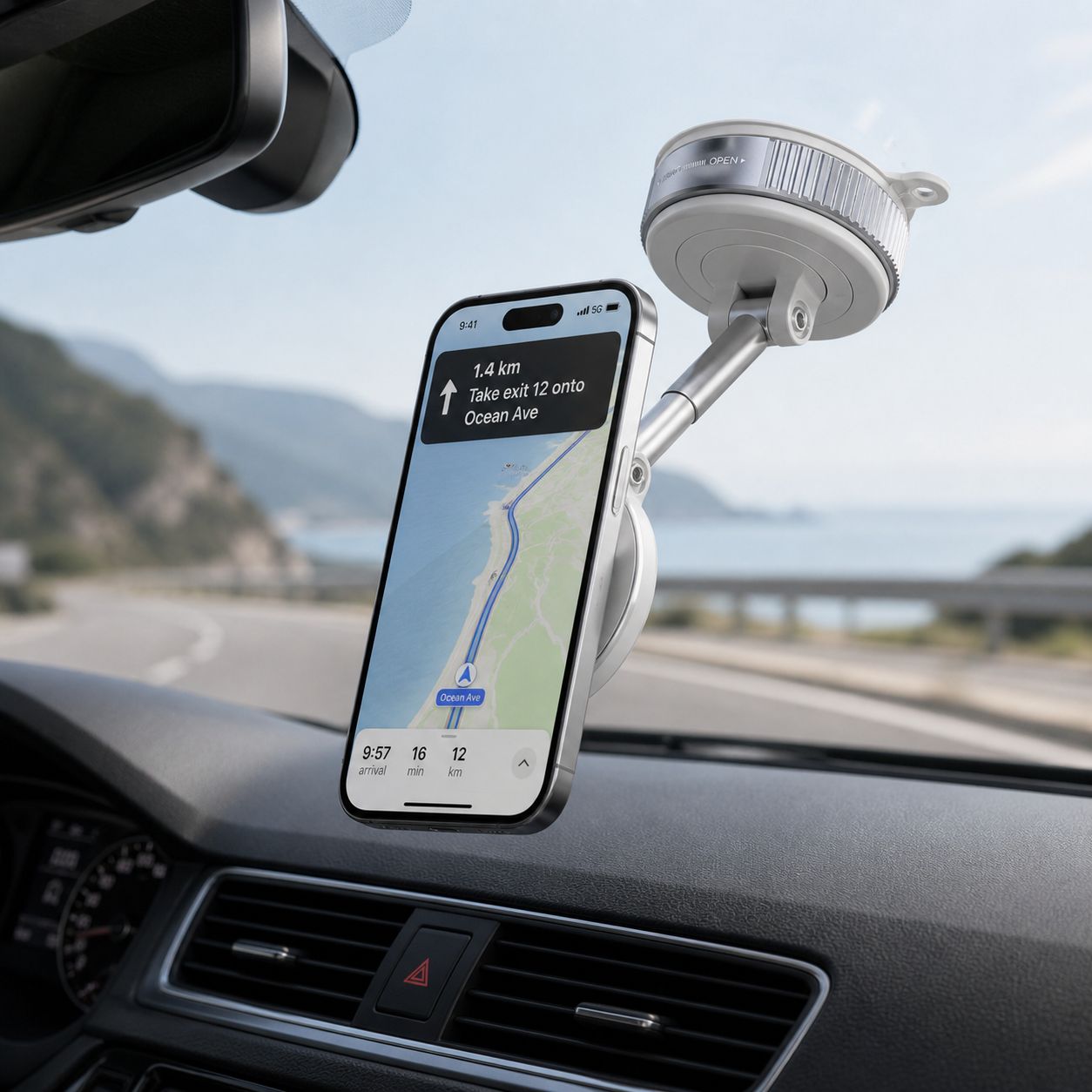 Luminomo Orbit magnetic phone mount attached inside a car for hands-free GPS navigation while driving on a coastal road.
